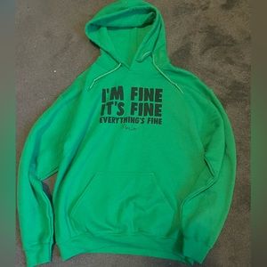 A sweater shirt that says “I’m fine it’s fine everything’s fine”